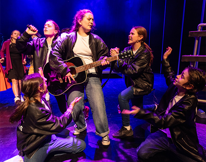 Children dressed as members of a band in story Gris